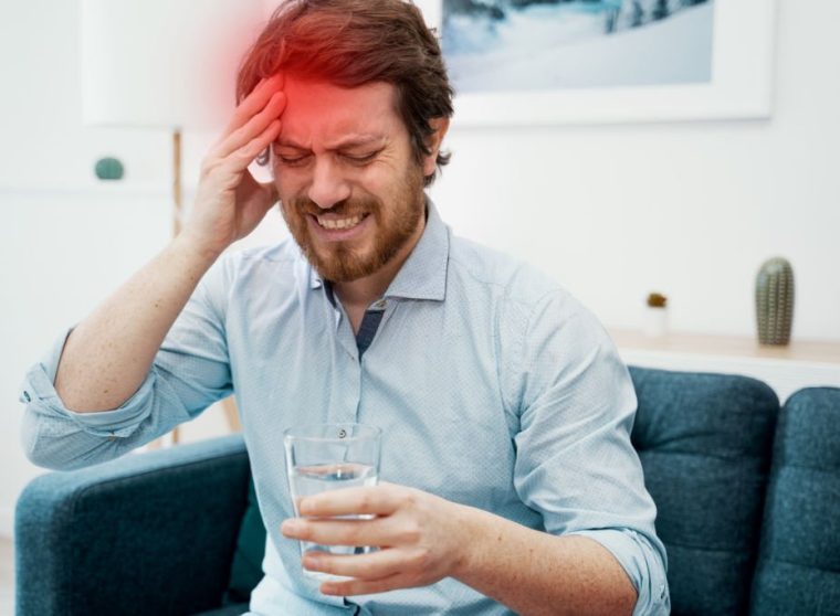 Thoughtful pensive serious male feeling head pain
